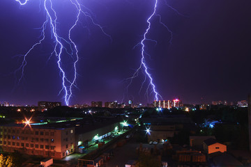 Night thunder lightning over the city sky view.