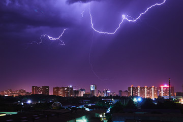 Night thunder lightning over the city sky view.