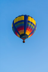 Colorful of balloon on blue sky with copy space, vertical