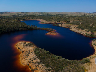 Aerial view from a pond with contaminated waters of an old mine
