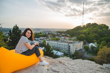 woman drinking coffee with beautiful view of sunset over lviv city in ukraine