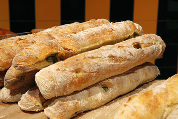 Baguette with spinach. Many fresh baguettes. Baguettes from bakery.