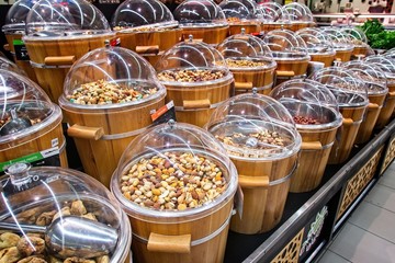Dried fruits for sale on the market in wooden buckets with lids