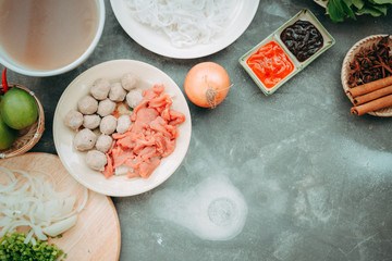 Traditional vietnamese noodle soups pho in bowls, concrete background. Vietnamese beef soup pho bo,...