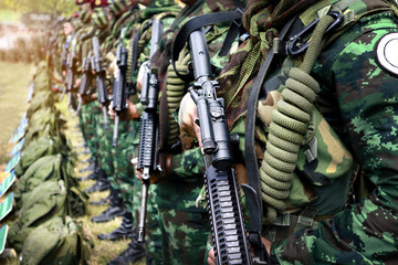 Thai soldiers stand in row.commando soldiers in camouflage uniforms gun in hand,close up of army and preparation for battle