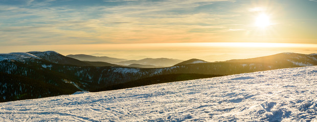 Eastern Sudetes, winter sunset over the panorama of mountain peaks.