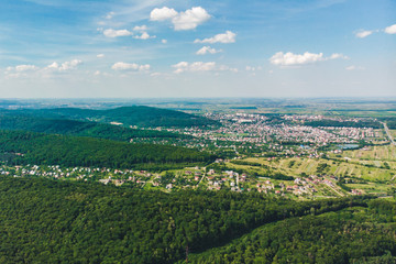 Fototapeta na wymiar aerial view of the city in the center of green forest