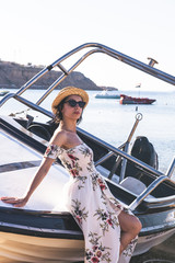 happy woman sitting on yacht and looking forward