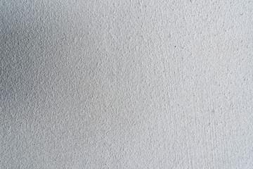 Texture of concrete wall surface painted with white color. Suitable for use as a pattern or background image for use in graphic design.