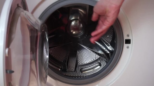 Putting Laundry Detergent Pod into the Washing Machine