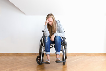 Despair young woman on wheelchair. Hard invalid concept.