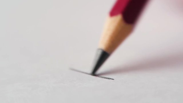 Artist hand drawing and stroking a gray lines with a wooden pencil on white paper. Close up, 4k