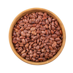 pinto beans in a wooden bowl isolated on a white background