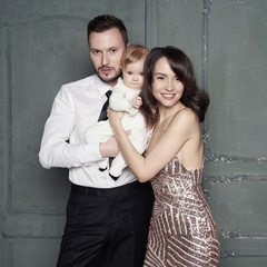 Young family with beautiful little baby in thair arms.