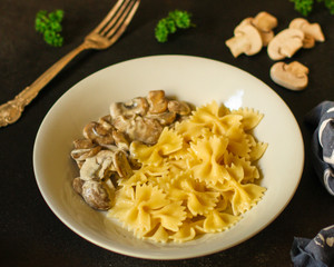 pasta farfalle with mushrooms and cream sauce (traditional). food background. top