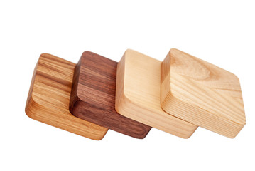 Assortment of wood handcraft pieces in row on white background