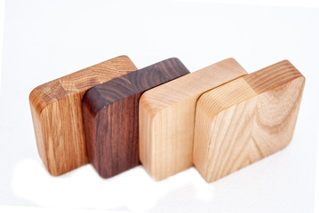 Assortment of wood handcraft pieces in row on white background