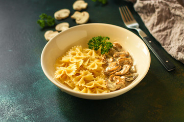 pasta farfalle with mushrooms and cream sauce (traditional). food background. top
