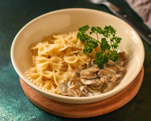 pasta farfalle with mushrooms and cream sauce (traditional). food background. top