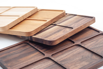 Shaped wooden boards in row on white background