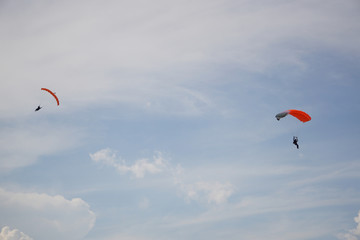   Two skydiver is flying in the blue sky against the background of clouds