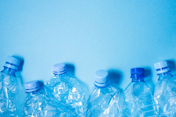 Crumpled plastic bottles of mineral water. Plastic waste background. Copy space for your text.