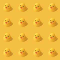 repeatable pattern of yellow rubber duck on yellow background Modern style. creative photography.