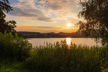 Naklejka na ściany i meble Beautiful sunset over the lake.