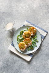 Fish cutlets with green peas and beans