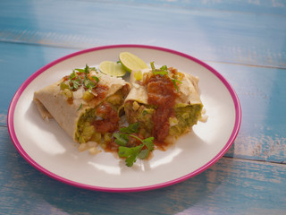 Soft Tortilla Chicken Burrito with Avocado and Spicy Tomato Sauce and a touch of Lime 