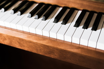 Rustic piano: close up picture of classical piano keys, selective focus