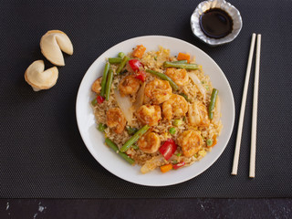 Shrimps with Rice and Vegetables Cantonese Style on a White Plate with Soy Sauce 