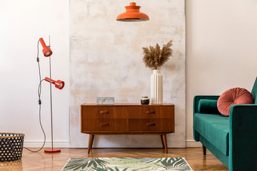 Stylish compositon of retro home interior with vintage cupboard, velvet sofa, flowers in vase,...