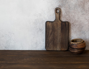 Food background with wooden cutting board and set of bowls