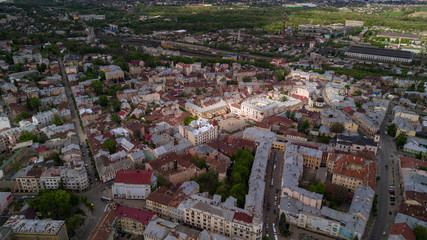 Fototapeta premium Aerial summer view of central part of beautiful ancient ukrainian city Chernivtsi with its streets, old residential buildings, town hall, churches etc. Beautiful town. UNESCO world heritage site.