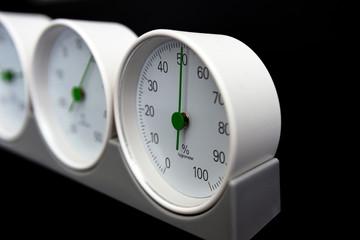 Barometer, thermometer, hygrometer isolated on black background.