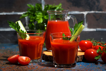 fresh tomato juice with celery in glass cups, closeup