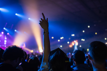 hands to the skies of people dancing and having fun at the live music concert