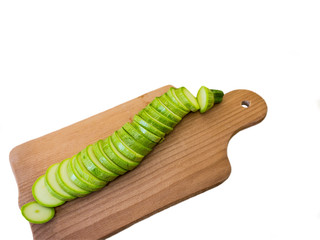 Slicing zucchini on a white background.