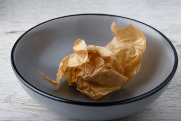 Crumpled paper in empty bowl