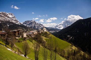 Fototapeta na wymiar Beautiful mountain scenery in the Alps with fresh green meadows in bloom on a beautiful sunny day in springtime. Dolomiti montains in Italy. Landscape in spring in Europe. 