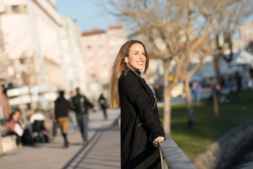 Fototapeta premium Beautiful girl listening to the music with earphones