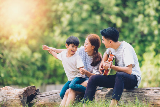 Happy Harmonious Family Outdoors Concept.father Mother And Son Have Activities Together On Holidays.