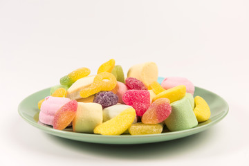 Plate with sweets isolated on a white background. Marmalade and marshmallow.