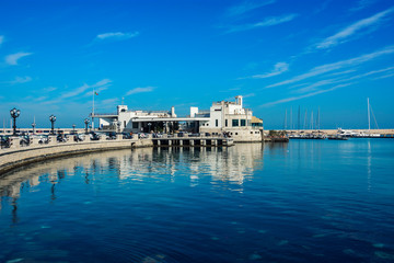 Fototapeta na wymiar Blue landscape with lungomare promenade in the old harbor of Bari on the Adriatic sea coast, Puglia region, Italy. 