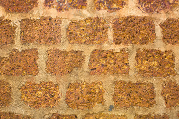 yellow gray brick wall of porous volcanic stones with light cement. rough surface texture