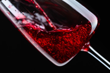Red wine being poured into wineglass.