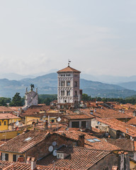 Tower of San Michele in Foro church over houses of Lucca, Tuscany, Italy