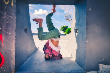 Young white dancer dancing hip-hop freestyle in a skate park