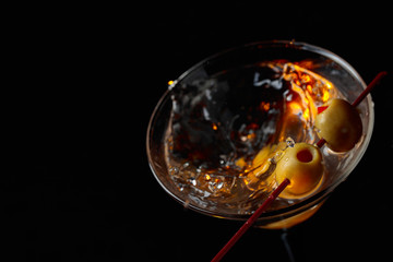 Martini cocktail with green olives.